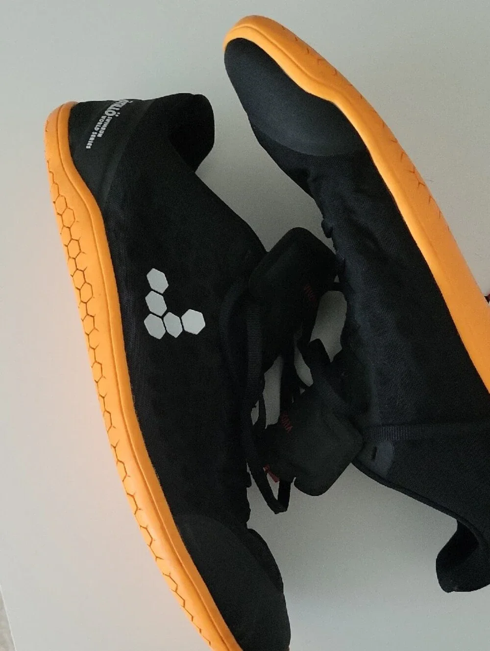 Vivo barefoot Men’s Black Athletic Shoes with Orange Sole